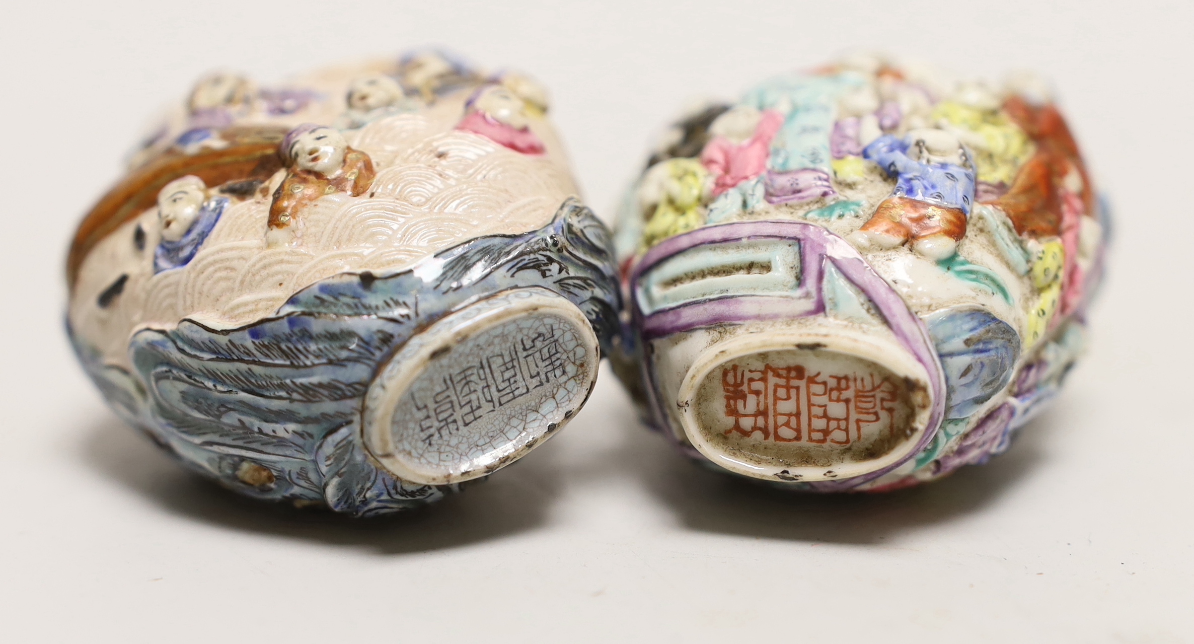 Two Chinese enamelled and moulded porcelain snuff bottles, Qianlong marks but mid 19th century
